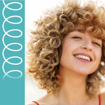 A woman with blonde curls smiles.